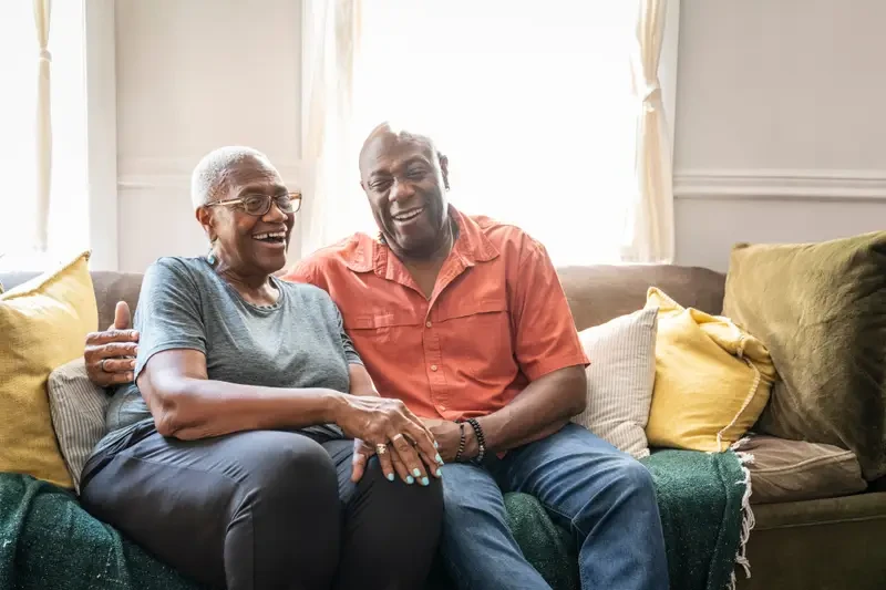 Smiling retired couple enjoying their comfortable home